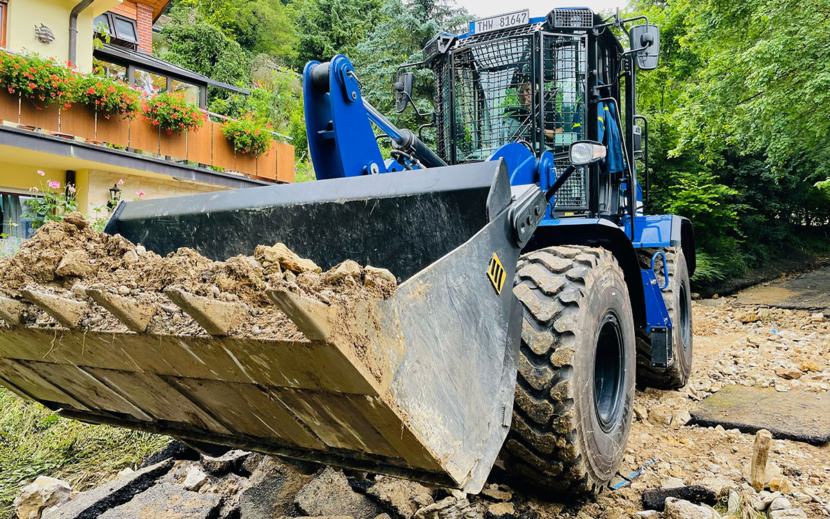 Viele Gebäude und Scheunen sind nach dem Hochwasser einsturzgefährdet. THW-Kräfte sicherten in Odendorf in NRW Großfahrzeuge aus einer beschädigten Scheune, bevor diese abgerissen werden musste.<br>Quelle: THW/Maximilian Christ